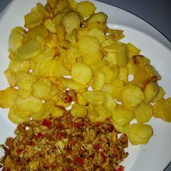 A picture of Fried potatoes with scramble egg sauce.
