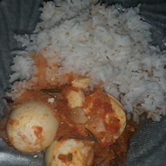 A picture of White rice and egg curry.