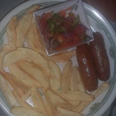 A picture of Fries, sausage and kachumbari.