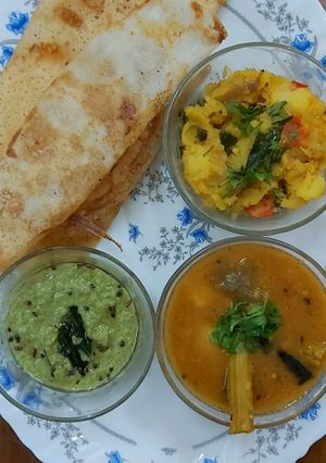 A picture of South Indian cuisine platter(dosa,sambar,chutney,potato veggie).