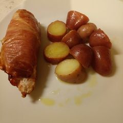 A picture of Ricotta stuffed chicken with a potato salad.