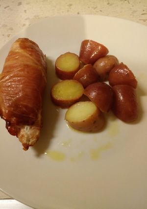 A picture of Ricotta stuffed chicken with a potato salad.