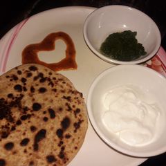 A picture of Aaloo ke parathe with green chutney and dahi.....!!.