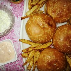 A picture of Chicken Burgers with garlic mayo sauce,coleslaw and french fries.