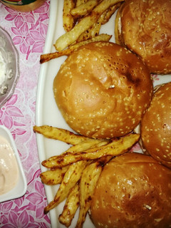 A picture of Chicken Burgers with garlic mayo sauce,coleslaw and french fries.
