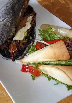 Una foto de Bocata de calamares con pan negro con tinta de calamar y cucuruchos de calamares con ensalada
