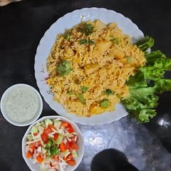 A picture of Alu Biryani with kachumar salad.