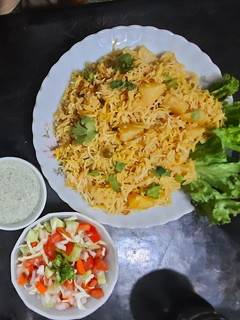 A picture of Alu Biryani with kachumar salad.