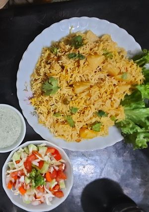 A picture of Alu Biryani with kachumar salad.