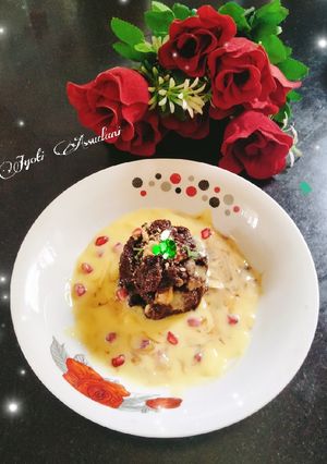 A picture of Chocolate Bread pudding with custard sauce.