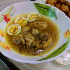 A picture of Peshawri chicken soup with baked potato.