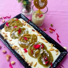 A picture of Spinach jalebi with nutty cheese rabdi.