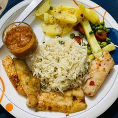 Baked fish with garlic rice sauté vegs and morrocon sauce A picture of Baked fish with garlic rice sauté vegs and morrocon sauce.
