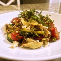 A picture of Tortellini olive tapenade with marinated tomatoes and cucumbers.
