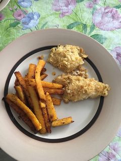 A picture of Fish and chips with polenta fries.