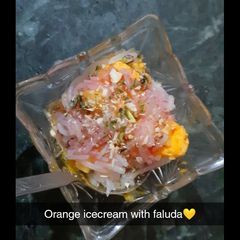 A picture of Orange ice cream with faluda.