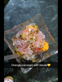 A picture of Orange ice cream with faluda.