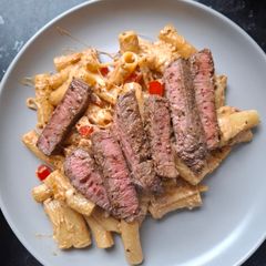 A picture of Steak and Italian pasta.