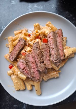 A picture of Steak and Italian pasta.