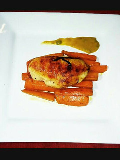 A picture of Grilled Chicken with Braised Flavoured Carrots and Tumeric Sauce.