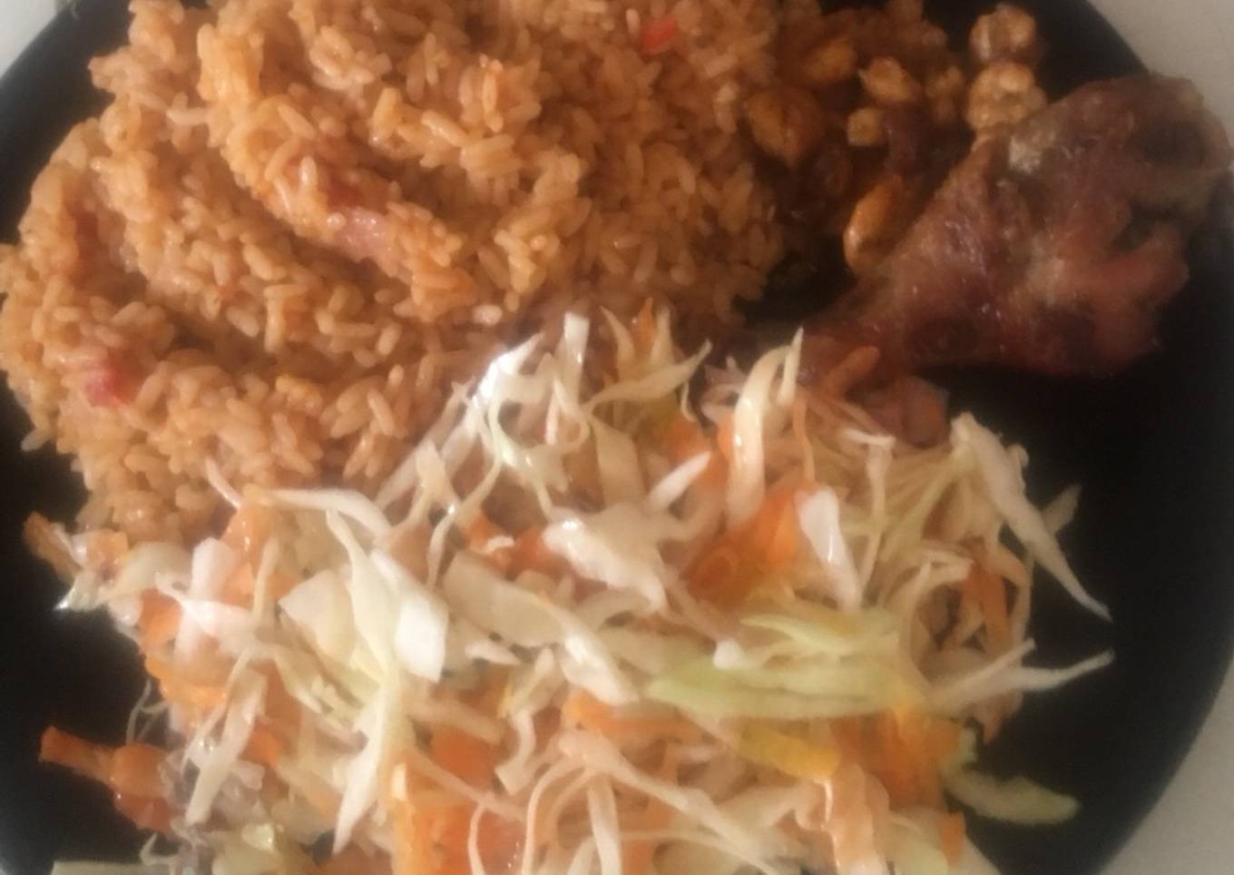 Jollof Rice with salad,pan fried shrimps with fried chicken