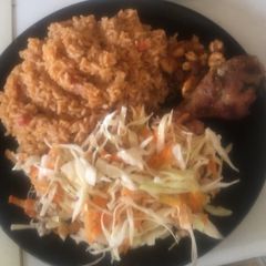 Jollof Rice with salad,pan fried shrimps with fried chicken A picture of Jollof Rice with salad,pan fried shrimps with fried chicken.