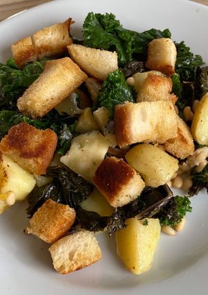 A picture of Cornish new potatoes with kale, Buttered croutons, pine nuts and Cornish blue cheese.