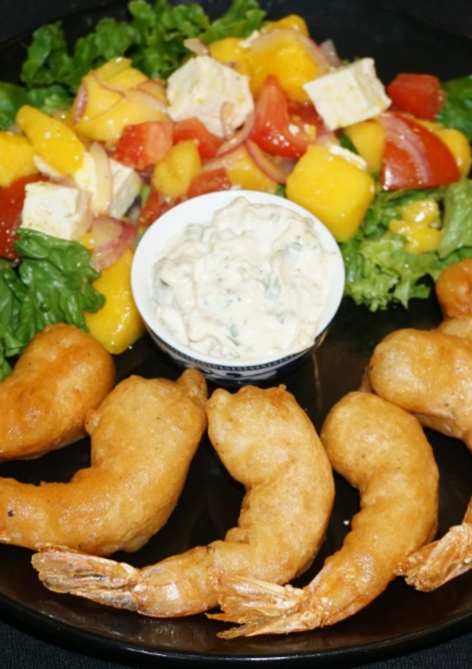 Una foto de Camarones fritos con batido de cerveza y ensalada de mango con queso de cabra