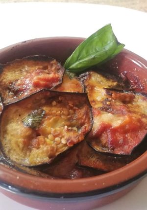 A picture of Eggplant Parmigiana with Mozzarella in a Terracotta Dish.