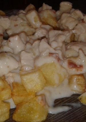 Una foto de Papas fritas con salsa de pollo