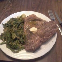A picture of T-Bone Steak w/Lemon Herb Butter and Vegetable Medley.