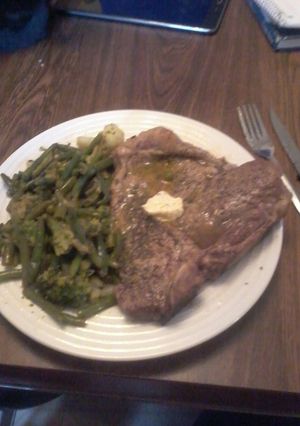 A picture of T-Bone Steak w/Lemon Herb Butter and Vegetable Medley.