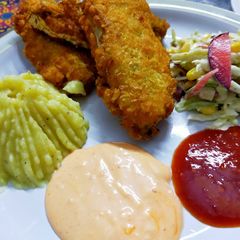 Fried fish restaurant style with salad,mash potato and dips A picture of Fried fish restaurant style with salad,mash potato and dips.