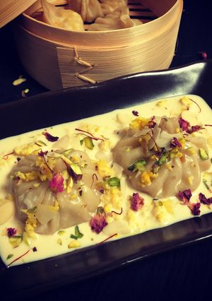 A picture of Kalakand Momo drizzled with Rabdi.