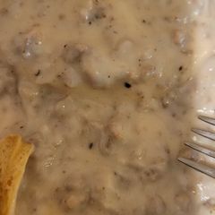 A picture of Sausage gravy and biscuits.
