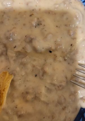 A picture of Sausage gravy and biscuits.