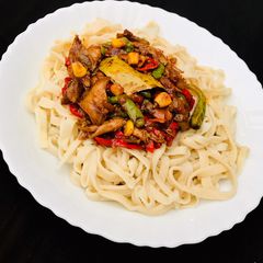 A picture of Homemade egg pasta with shredded chicken sauce.