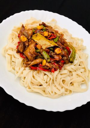A picture of Homemade egg pasta with shredded chicken sauce.