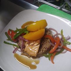 A picture of Peach Bourbon Salmon w/ Cranberry Cous cous and Vegetable Medley.