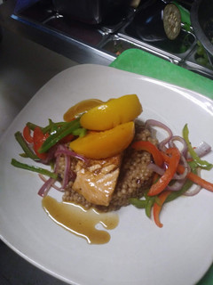A picture of Peach Bourbon Salmon w/ Cranberry Cous cous and Vegetable Medley.