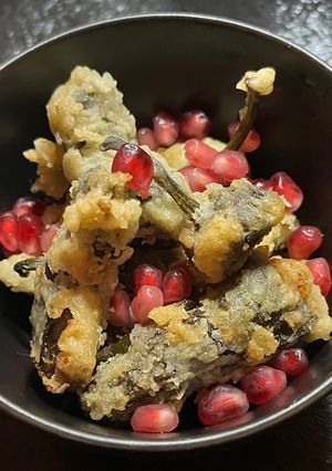 A picture of Lightly battered Padron Peppers filled with cream cheese.
