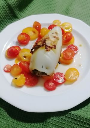 A picture of Eggplant-Stuffed Calamari on a Bed of Cherry Tomatoes.