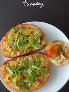A picture of Egg-cellent Cheesy Arugula Morn 🍳🧀🌿.