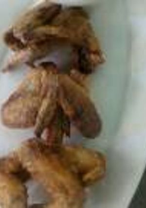 A picture of Chicken wings and kachumbari.