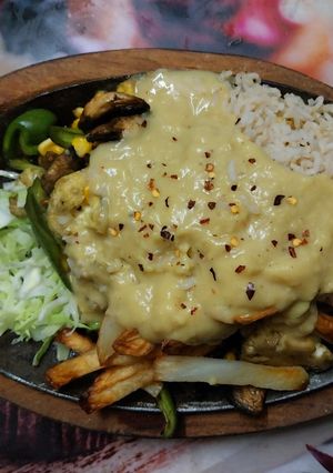 A picture of Veg Sizzler with Yellow garlic sauce.