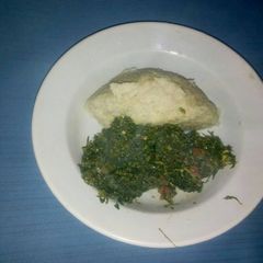 A picture of Ugali,kales and eggs.