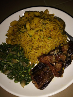 A picture of Jollof Rice and Irish with vegetable Sauce and Cat Fish.