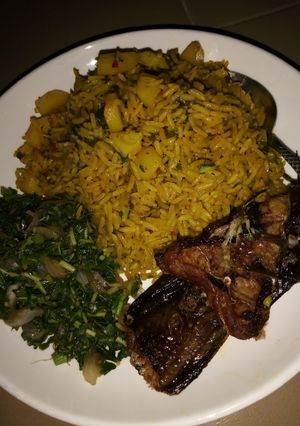 A picture of Jollof Rice and Irish with vegetable Sauce and Cat Fish.