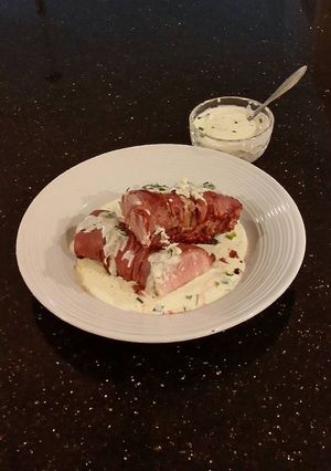 A picture of Roast Pork Tenderloin wrapped with Pastrami and served with a Romano / Marscapone Cream Sauce.