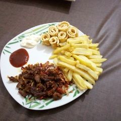 A picture of Fried chips and fried egg with Asun.